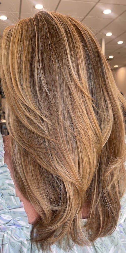 Long layered copper and golden blonde hair by a Poway stylist