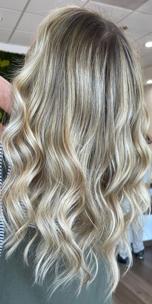 Bright blonde balayage with soft beach waves
